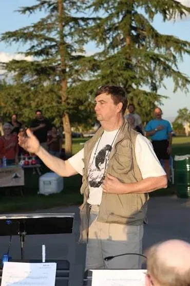 Commander Lefrige speaking at an outdoor band event