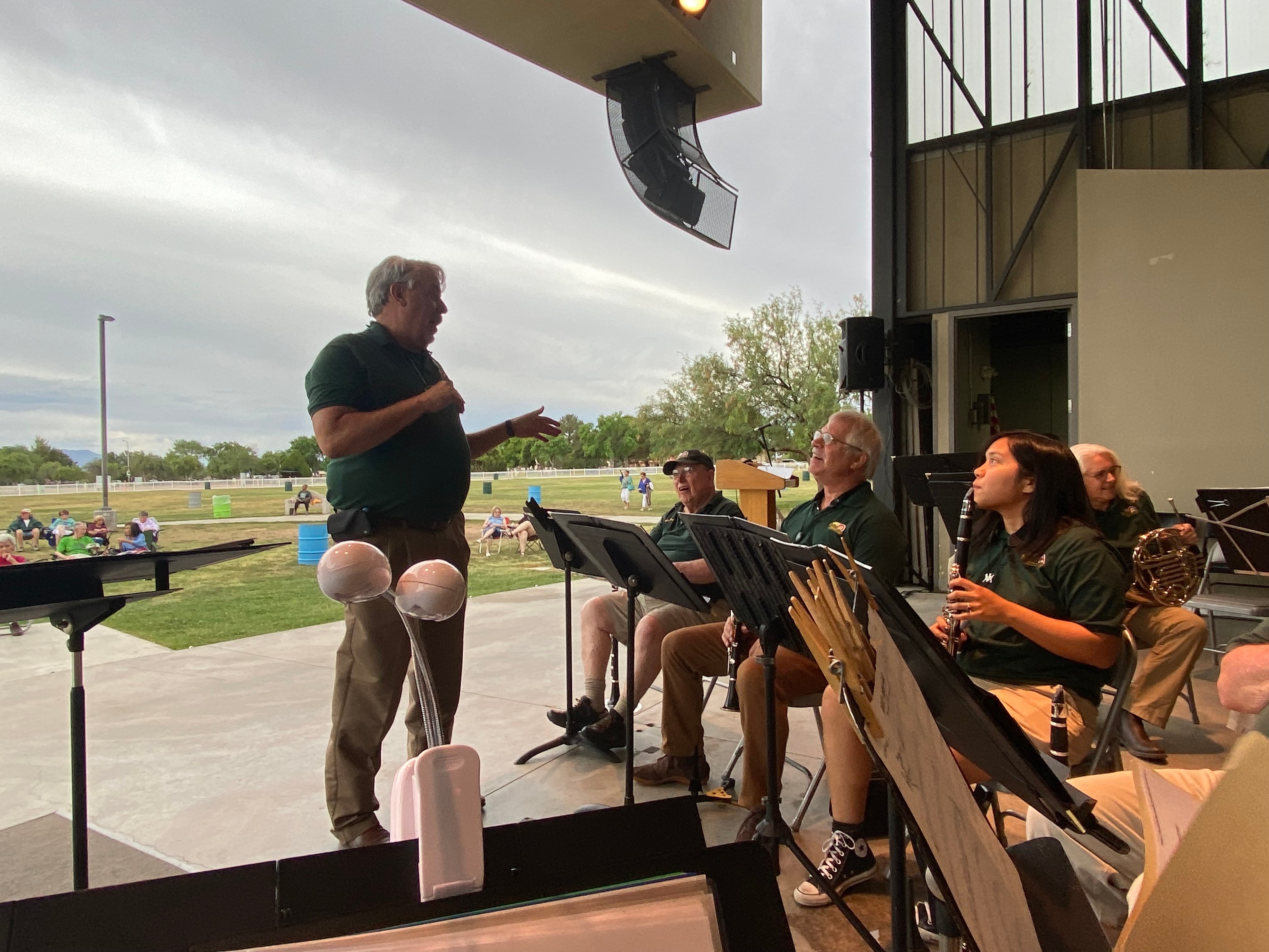 President Brad Clark addressing band members on stage at Veterans Memorial Park pavilion