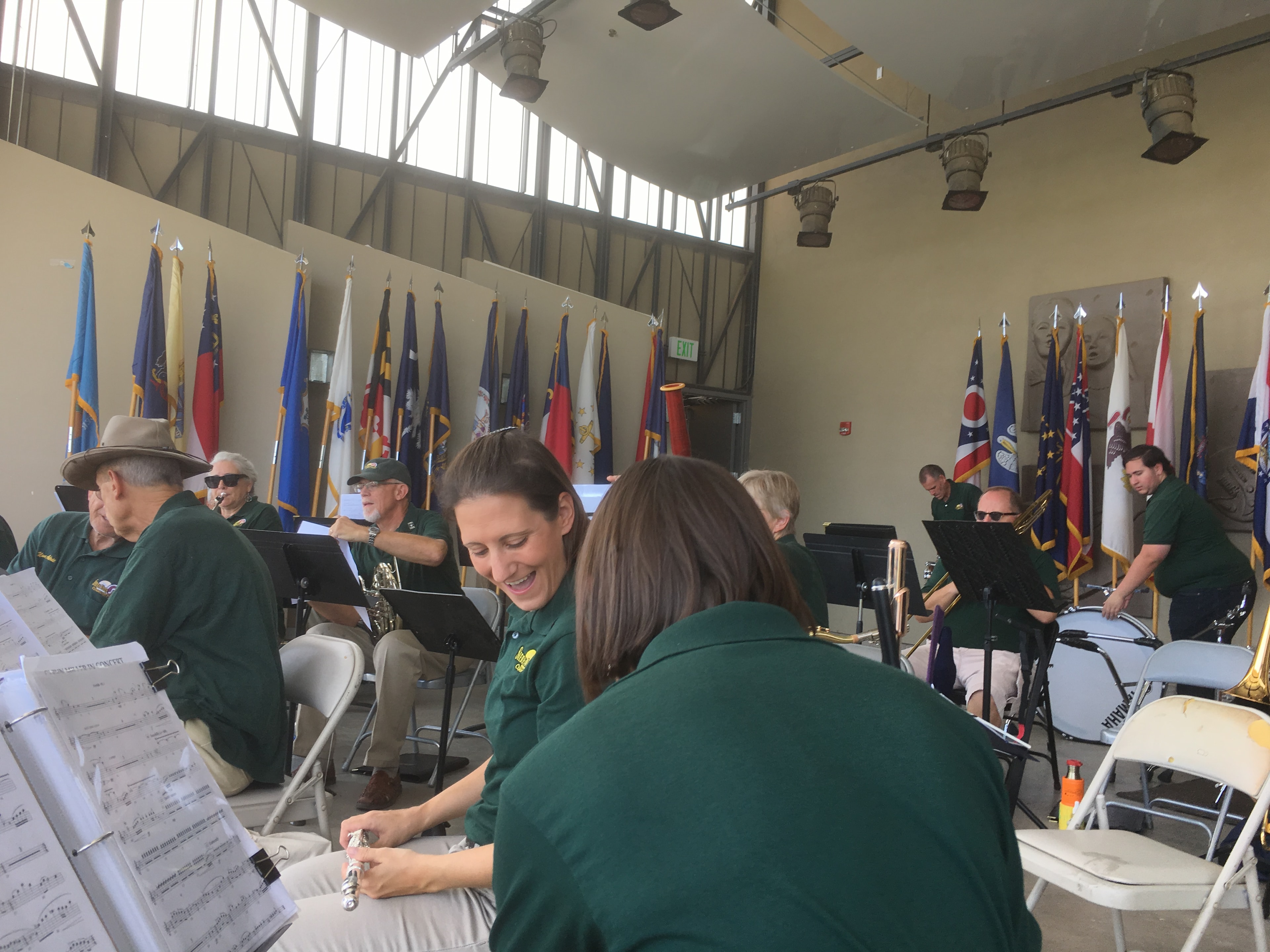 Sierra Vista Community Band woodwind section rehearsing surrounded by state and military flags